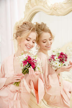 Bride with wedding flowers bouquet. Woman in wedding dress. Young fashion model with perfect skin, make up and Beautiful Hairstyle. happy day. Marriage.の写真素材