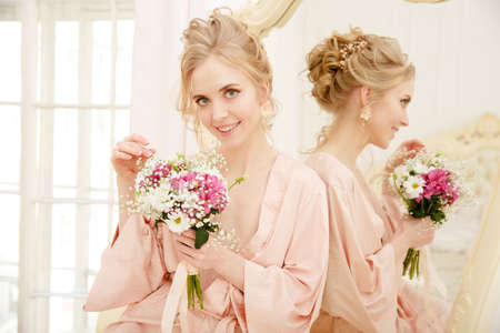 Bride with wedding flowers bouquet. Woman in wedding dress. Young fashion model with perfect skin, make up and Beautiful Hairstyle. happy day. Marriage.の写真素材