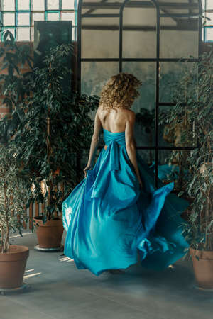 Elegant woman in a long vintage blue dress. Fabulous girl. Cover of a love story.の写真素材