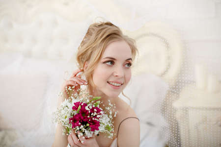 Bride with wedding flowers bouquet. Woman in wedding dress. Young fashion model with perfect skin, make up and Beautiful Hairstyle. happy day. Marriage.の写真素材