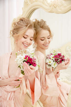 Bride with wedding flowers bouquet. Woman in wedding dress. Young fashion model with perfect skin, make up and Beautiful Hairstyle. happy day. Marriage.の写真素材