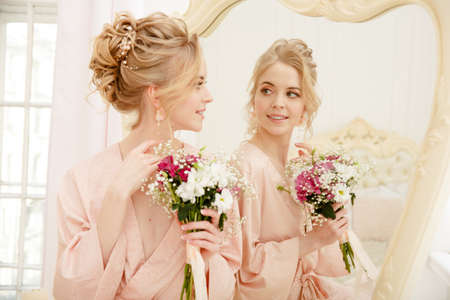Bride with wedding flowers bouquet. Woman in wedding dress. Young fashion model with perfect skin, make up and Beautiful Hairstyle. happy day. Marriage.の写真素材