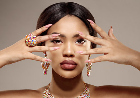 Beauty black skin woman African Ethnic female face. Luxury Young african american model with jewelry, earrings and ringの写真素材