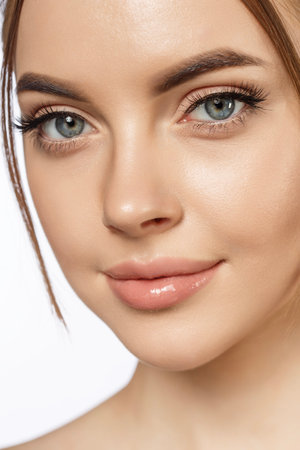 Beauty young woman with clean glowing fresh Close-up Skin on face. Beautiful elegance Girl facial treatment. Lady with perfect smooth skin. Concept of natural beauty, skin care, plastic surgery, spa, cosmetology, cosmetics.の写真素材
