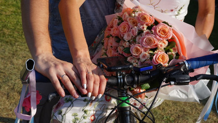 Bridal bouquet on bike in the hands of the bride