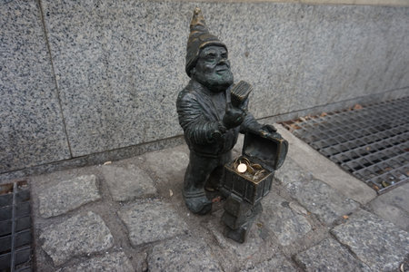 Sculpture of a man with a lantern in the streetの写真素材