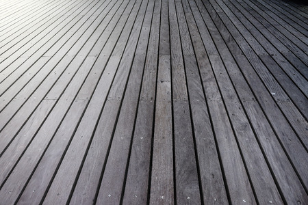 Wooden plank floor of a pier going to one direction and light from the left cornerの写真素材