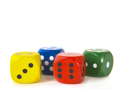 Four colorful gaming dices in a row on a white background background