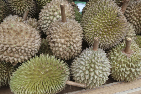 Close-up of durian fruits lying on a market stall tableの写真素材