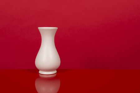 Empty white vase, on a red design interiorの写真素材