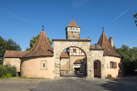 Rothenburg ob der Tauber, Germany - July 23, 2019; Medieval RÃ¶der Gate of Rothenburg ob der Tauber a old touristic city in Bavaria on the Romantic road in Germanyのeditorial素材