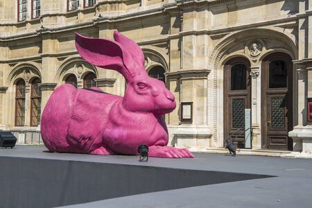 Austria, Vienna - June 4, 2019: Pink young DÃ¼rer hare statue next to next to the Vienna State Opera building in Vienna to honer the drawing of the young hare of Albrecht DÃ¼rerのeditorial素材