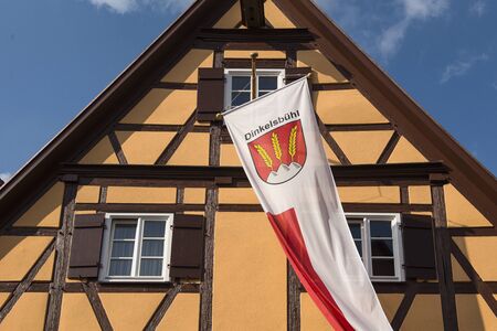 Dinkelsb hl, Germany - July 15, 2019; Old half timbered house with the flag of Dinkelsb?hl a popular touristic city in Bavariaのeditorial素材