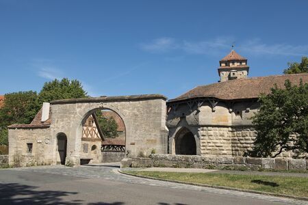 Rothenburg ob der Tauber, Germany - July 23, 2019; City gate called Spiraltor an medieval gate and a tourist atraction in the touristic town Rothenburg on the romantic road in Bavariaの写真素材