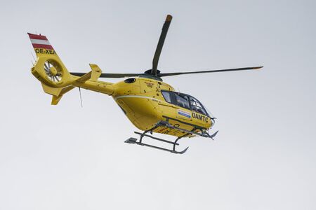 Vienna, Austria - June 10, 2019; Ambulance rescue helicopter seen from an low angle flying on a blue skyのeditorial素材
