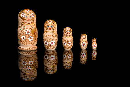 Wooden Russia matrioshka dolls in a row on a blackgroundの写真素材