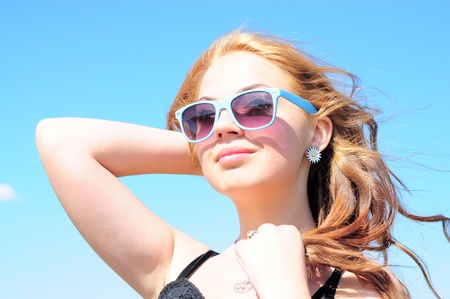 Beautiful young woman smiling in the sun