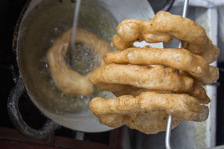 Peru Dish Dessert: BuÃ±uelos with chancaca traditional honey. Picture taken in Arequipa, Peru.