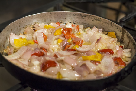 Aji (Chilli) Sauce - Peruvian chilli sauce preparation. Onion, garlic, rocoto, sunflower oil on a pan to be fried.の写真素材