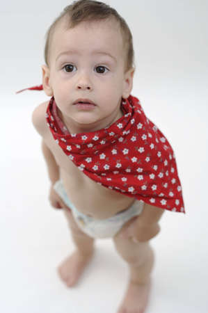 Baby with red scarf looking upの写真素材