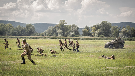 TEKOV, SLOVAKIA - JULY 26,2014:  Reconstruction of a World War II fight between Red army and German army. Red army is attacking german positions.のeditorial素材