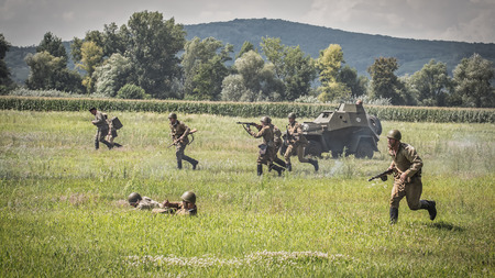 STARY TEKOV, SLOVAKIA - JULY 26,2014:  Reconstruction of a World War II fight between Red army and German army. Red army is attacking german positions.のeditorial素材