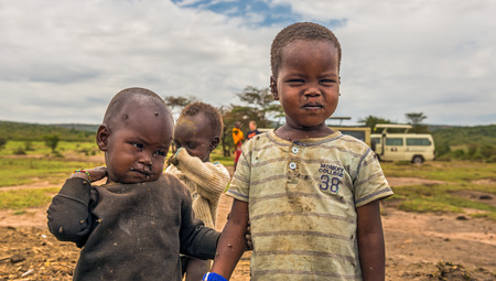 MASAI MARA, KENYA - OCTOBER 17, 2014: Two african boys from Masai tribe in their village. The Maasai are a Nilotic ethnic group living in southern Kenya and northern Tanzaniaのeditorial素材