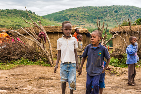 MASAI MARA, KENYA - OCTOBER 17, 2014: Two african boys from Masai tribe in their village. The Maasai are a Nilotic ethnic group living in southern Kenya and northern Tanzaniaのeditorial素材