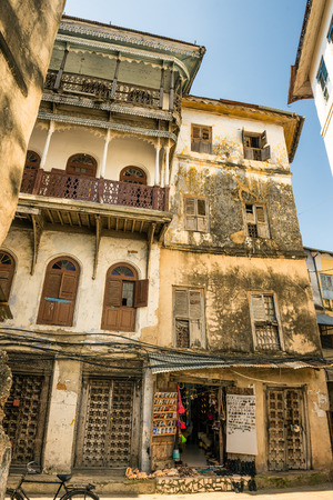 STONE TOWN, ZANZIBAR - OCTOBER 24, 2014: One of the typical narrow streets in Stone Town. Stone Town is the old part of Zanzibar City, the capital of Zanzibar, Tanzania.のeditorial素材