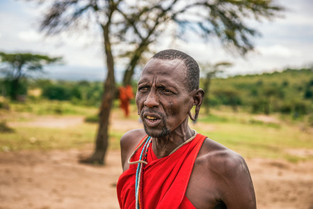 MAASAI MARA, KENYA - OCTOBER 17, 2014 : Portrait of an african men posing in his Masai tribe village. The Maasai are a Nilotic ethnic group living in southern Kenya and northern Tanzaniaのeditorial素材