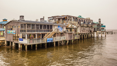 CEDAR KEY, FLORIDA - JANUARY 15, 2015 : Waterfront buildings on stilts in the historic downtown Cedar Key. Cedar Key is in the National Register of Historic Places since 1989.のeditorial素材