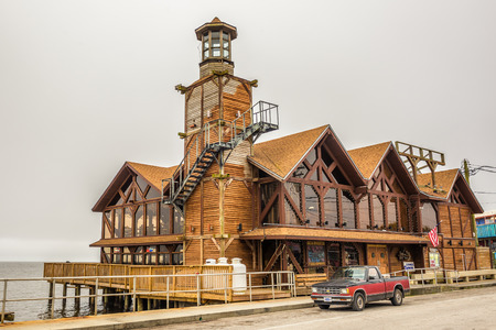 CEDAR KEY, FLORIDA - JANUARY 15, 2015 : The Sea Breeze Restaurant with a historic lighthouse in downtown Cedar Key. Cedar Key is in the National Register of Historic Places since 1989.のeditorial素材