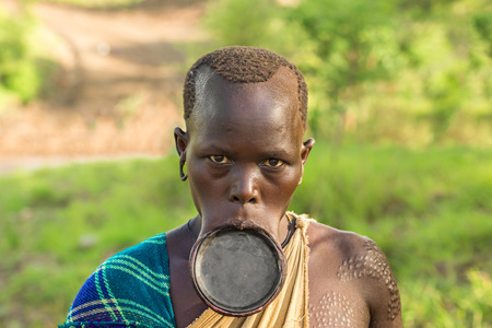 OMO VALLEY, ETHIOPIA - MAY 3, 2015 : Woman from the African tribe Surma with big lip plate.のeditorial素材