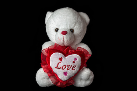 White teddy bear isolated on black background.の写真素材