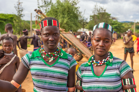 TURMI OMO VALLEY ETHIOPIA  MAY 5 2015: Two girls from the Hamar tribe with traditional jewelry at a popular local market.のeditorial素材