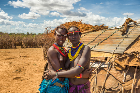 OMO VALLEY, ETHIOPIA - MAY 6, 2015 : Two sisters from the african tribe Daasanach in their village.のeditorial素材