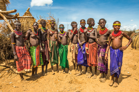 OMO VALLEY, ETHIOPIA - MAY 6, 2015 : Girls and women from the african tribe Daasanach in their village.のeditorial素材
