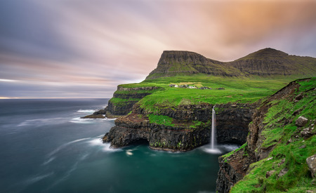 Gasadalur village and its iconic waterfall, Vagar, Faroe Islands, Denmark. Long exposure. Gasadalur village and its iconic waterfall, Vagar, Faroe Islands, Denmark. Long exposure.