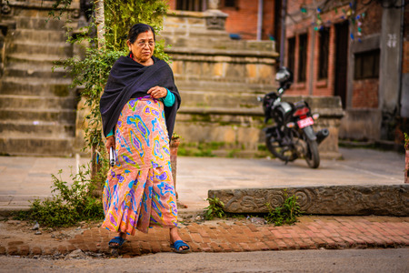 KATHMANDU, NEPAL - OCTOBER 19, 2015 : Old nepalese lady walking in Kathmanduのeditorial素材