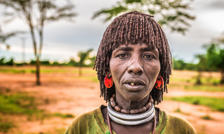 TURMI, OMO VALLEY, ETHIOPIA - MAY 5, 2015: Woman from the Hamar tribe at a local market in south Ethiopia.のeditorial素材