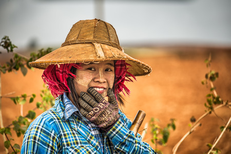 SHAN, MYANMAR - JANUARY 25, 2016 : Portrait of a young female farmer working in a fieldのeditorial素材