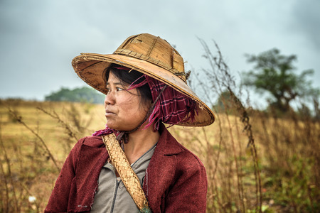SHAN, MYANMAR - JANUARY 25, 2016 : Portrait of a young female farmer working in a fieldのeditorial素材