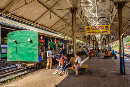 YANGON, MYANMAR - JANUARY 19, 2016 :  Train station in Yangon and waiting passengers. Yangon Circular Railway is the local rail network that serves the Yangon metropolitan area.のeditorial素材
