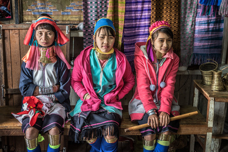 INLE LAKE, MYANMAR - JANUARY 26, 2016 : Three women of the Kayan Lahwi tribe wearing traditional metal rings on their necks. The The Kayan are a sub-group of Red Karen (Karenni people)のeditorial素材