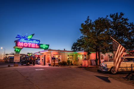 TUCUMCARI, NEW MEXICO - MAY 13, 2016 : Historic Blue Swallow Motel with vintage cars parked in front of it. This building is listed on the National Register of Historic Places in New Mexico as a part of historic U.S. Route 66.のeditorial素材
