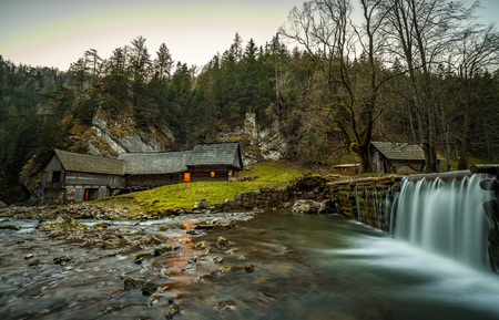 Old wooden water mill at National Nature Reserve Kvacianska dolina in Slovakia after sunset.  It has been restored and serves as a museum. Long exposure.の写真素材