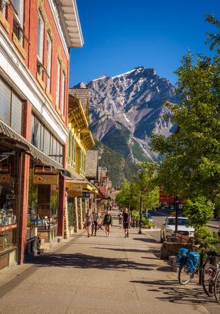 BANFF, ALBERTA, CANADA - JUNE 27, 2017 : Scenic street view of the Banff main shopping street in a sunny summer day. Banff is a resort town and popular tourist destination.のeditorial素材