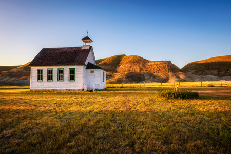 Summer sunset over the old wooden pioneer church in the ghost town of Dorothy in Alberta, Canada.の写真素材