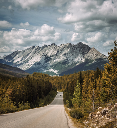 Scenic view of the road and canadian rockies on Icefields Parkway. It travels through Banff and Jasper National Parks and offers spectacular views of the Rocky mountains.の写真素材