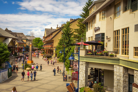 WHISTLER, BRITISH COLUMBIA, CANADA - JULY 2, 2017 : Scenic street view with many tourists  in Whistler Village. Whistler is a canadian resort town visited by over 2 million people annually.のeditorial素材